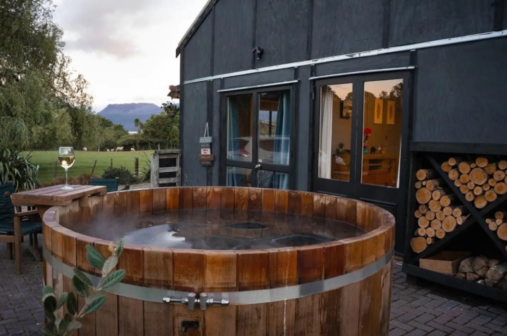 Zorb Rotorua New Zealand outdoor spa in front of barn style house